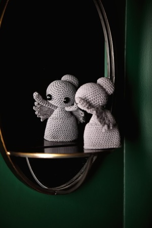 A crochet weeping angel looking in a mirror
