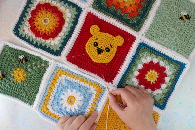 Crochet squares in various colors being joined together