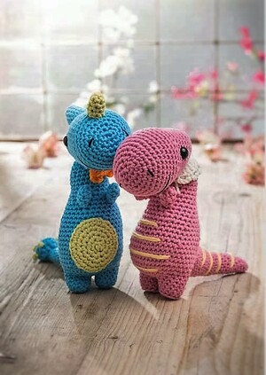 A pink and a blue crochet dinosaur