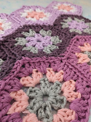 A close up of crochet hexagons